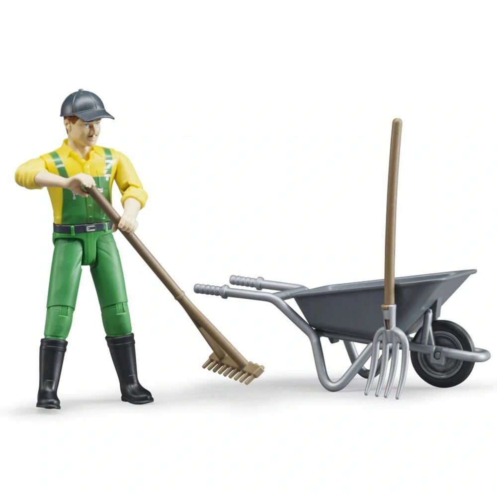 Farmer figure in green overalls with besom, standing next to a gray wheelbarrow and pitchfork.