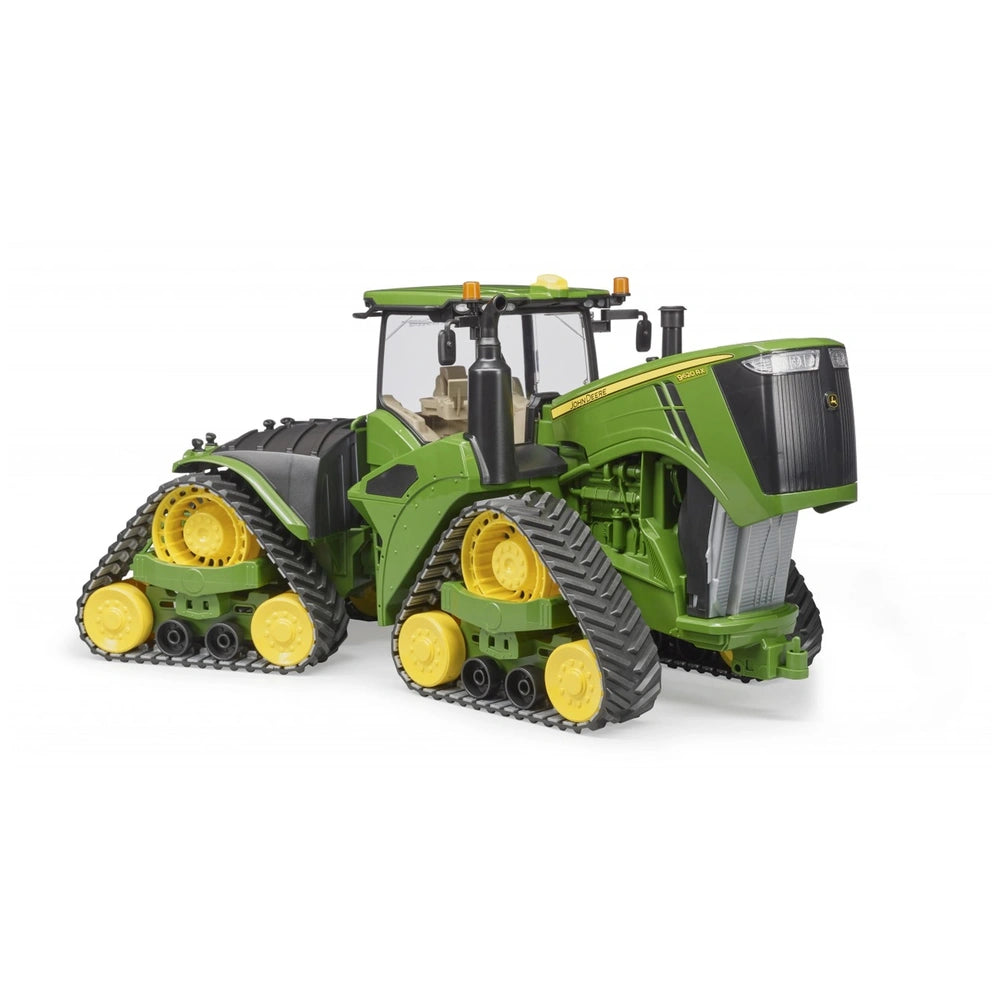 Green Bruder John Deere 9620RX toy tractor with yellow track belts, detailed cabin, and robust front design.