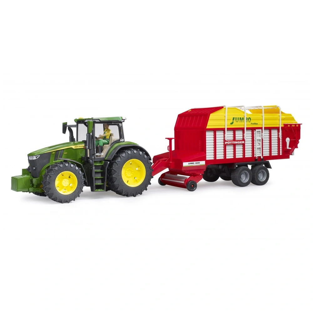 Green toy tractor towing red and yellow Bruder Pottinger Jumbo 6600 Profiline Forage Trailer on white background.
