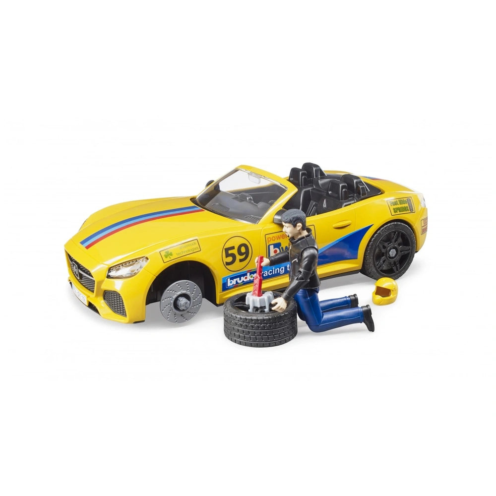Yellow convertible toy car with racing decals and number 59. Figures include mechanic, tire, tools, and helmet nearby.