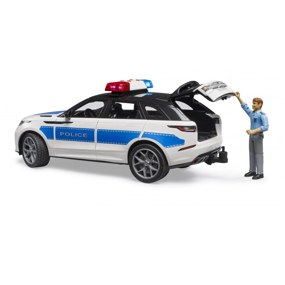 Bruder Range Rover Velar Police toy with officer, rear door open, blue and white with lights, 1:16 scale model.