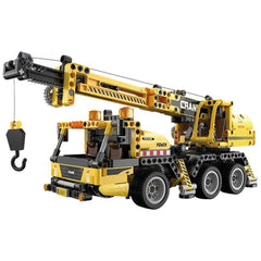 CaDA Mobile Crane Truck construction set in yellow with black accents, featuring a boom, hook, bucket, and wheels.