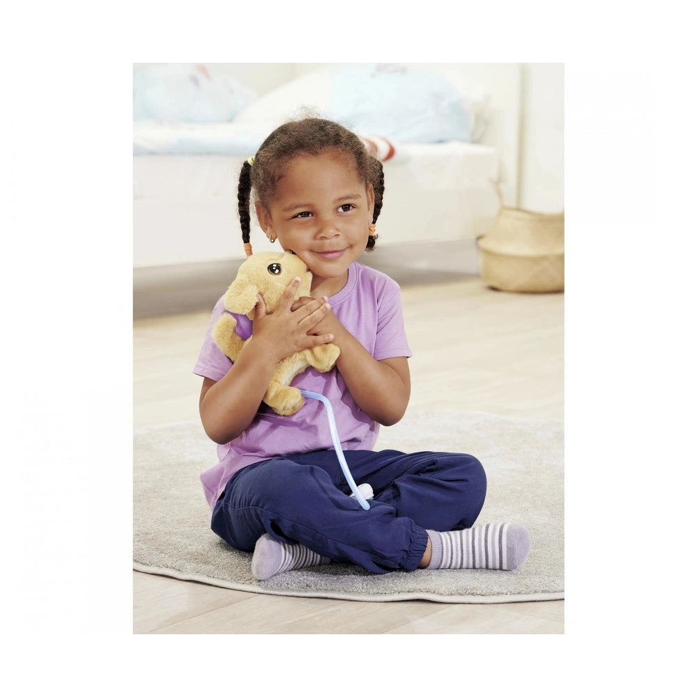 ChiChi LOVE Loomy Golden Retriever plush toy is being joyfully held by a smiling child sitting on a textured rug indoors.