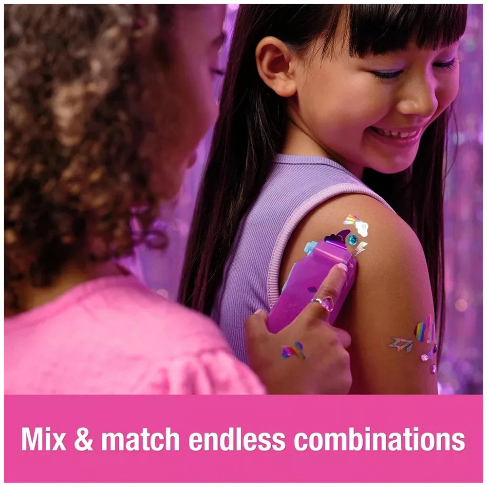 Cool Maker Shimmer Me Body Art Set showcases two smiling girls with colorful tattoos in a vibrant, playful indoor setting.