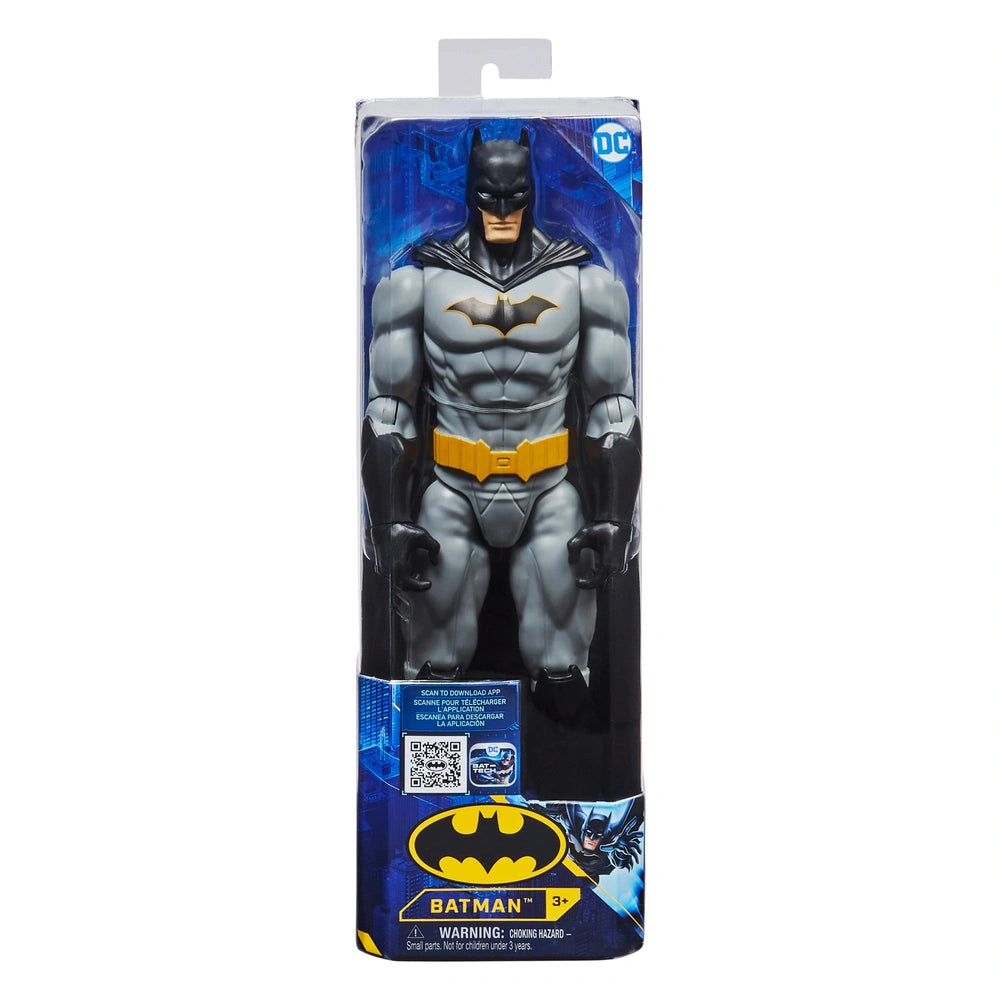 Batman Rebirth action figure stands upright in clear packaging with a blue background, showcasing its gray costume and yellow