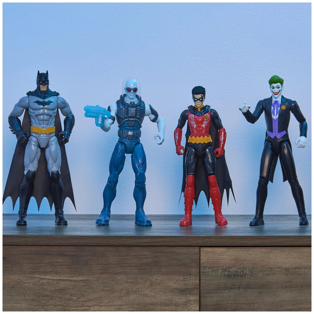 DC Comics Batman Rebirth action figure stands among two other superhero figures on a wooden surface against a light backgroun