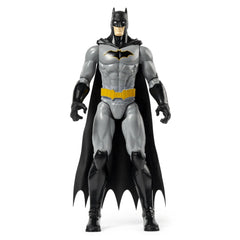 Batman Rebirth action figure stands in a dynamic pose, showcasing its grey bodysuit, black cape, and yellow emblem.