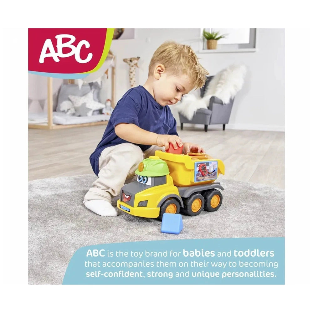 Dickie Abc Volvo Builder Team Play Vehicles packaging features a young child holding a red toy with a glossy finish and color