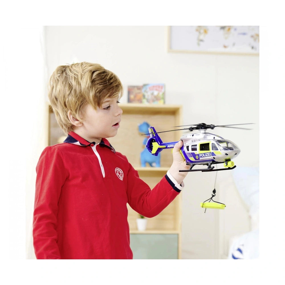 Dickie Police Helicopter Play Vehicle with blue body, yellow propeller, and a young boy playing in a lifestyle scene.