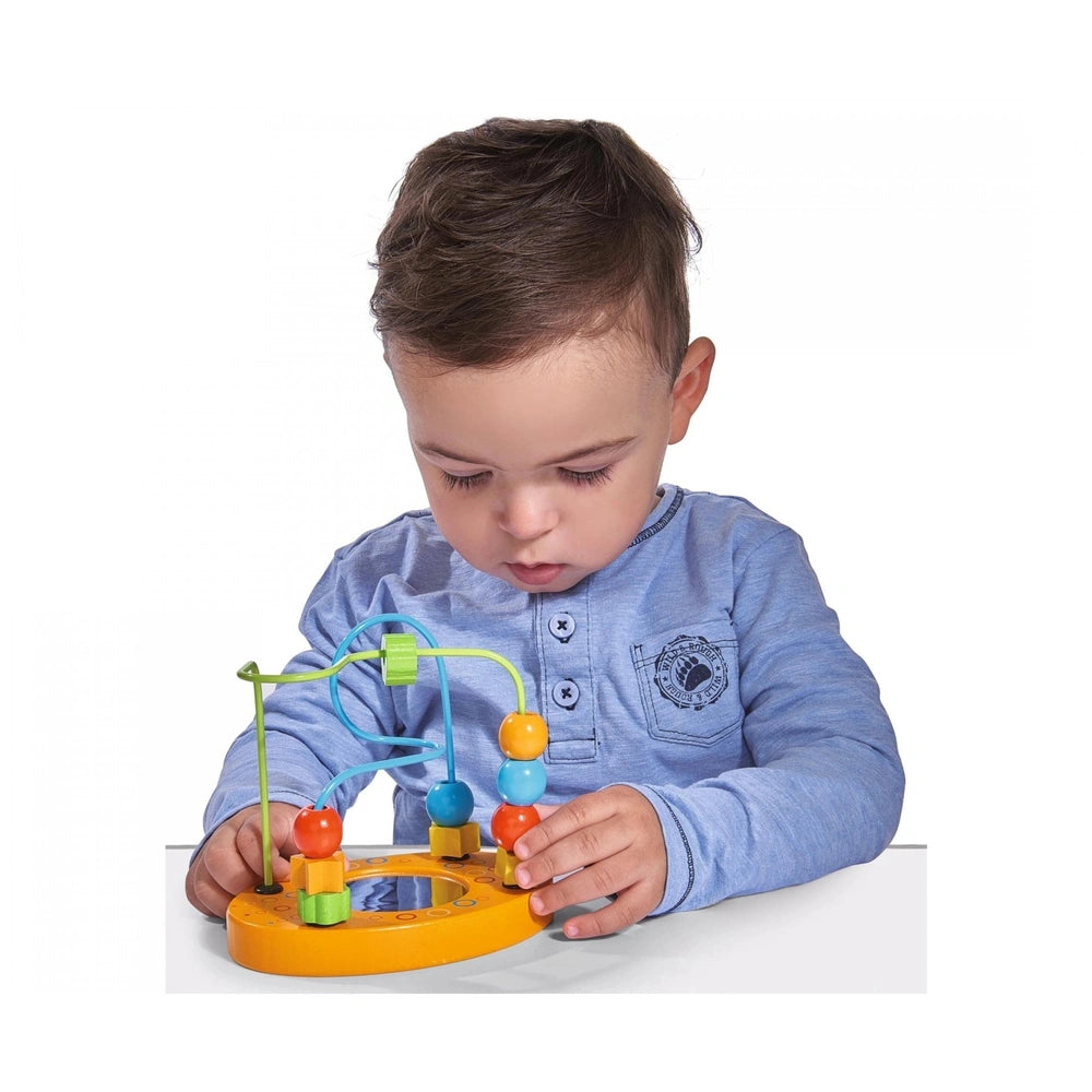 Eichhorn Beads Path toy engages a focused child in a blue shirt at a light table, surrounded by colorful components.