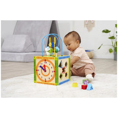 Eichhorn Color Little Play Center features a young child engaged with a colorful block structure with a clock face on a fluff
