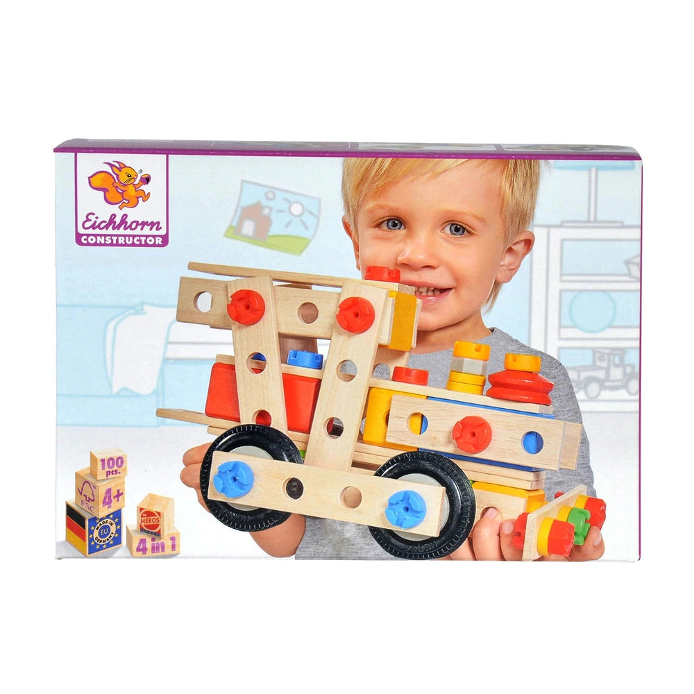 Eichhorn Constructor 4 in 1 construction set features a smiling child holding a colorful wooden toy with wheels.