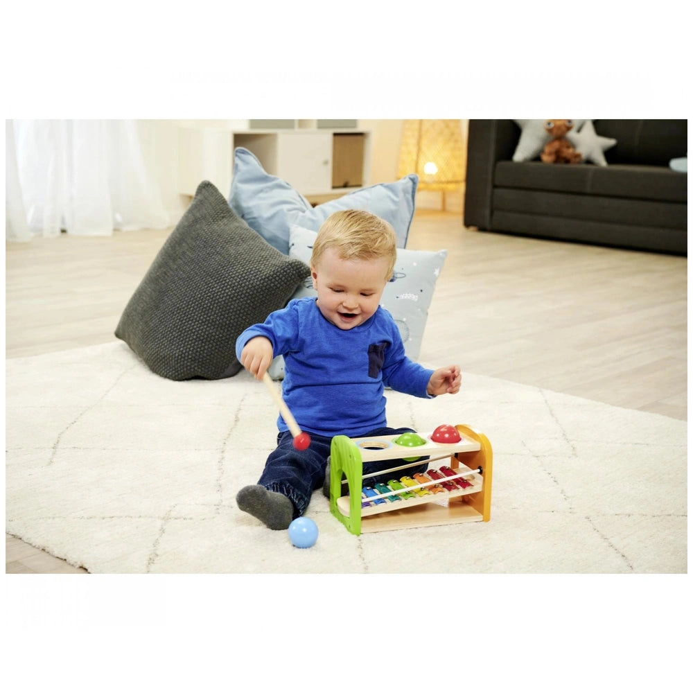Eichhorn Hammer Bench with Xylophone shown with a smiling child playing indoors on a cozy rug.