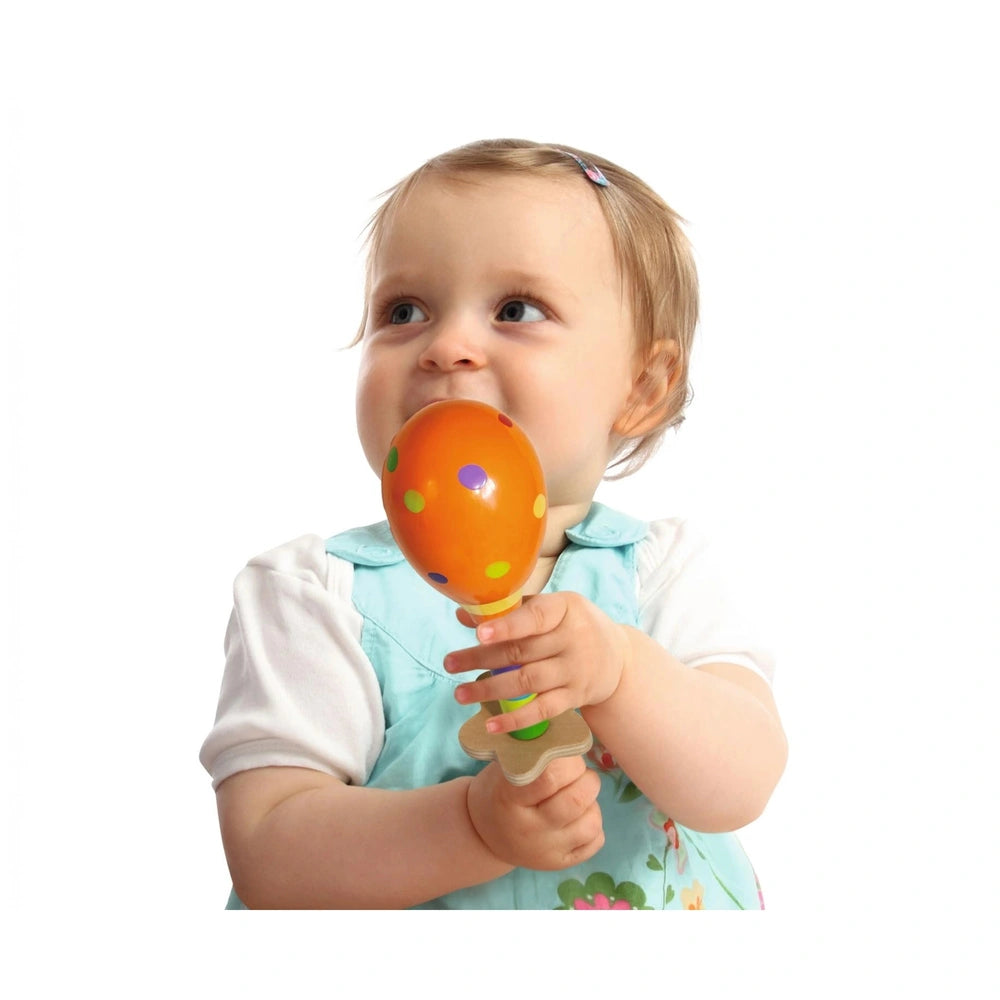 Eichhorn maracas held by a smiling child in a light blue shirt, showcasing vibrant colors and playful joy against a white bac