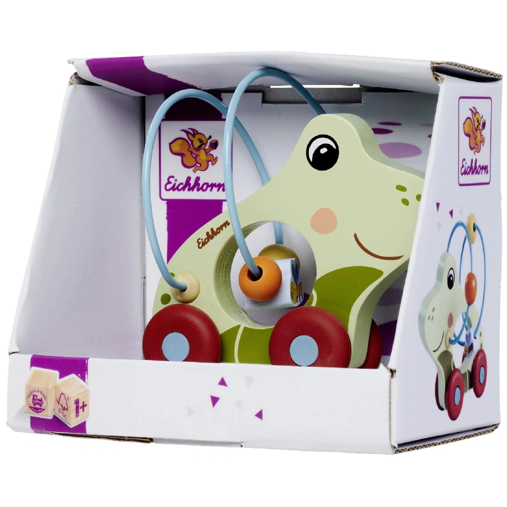 Eichhorn Push Frog baby activity toy in a box, featuring a green frog ride-on vehicle with red wheels and a purple seat.