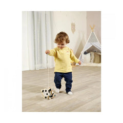 Eichhorn Wooden Pull Animal Panda toy held by a child in a bright indoor play area with a teepee backdrop.