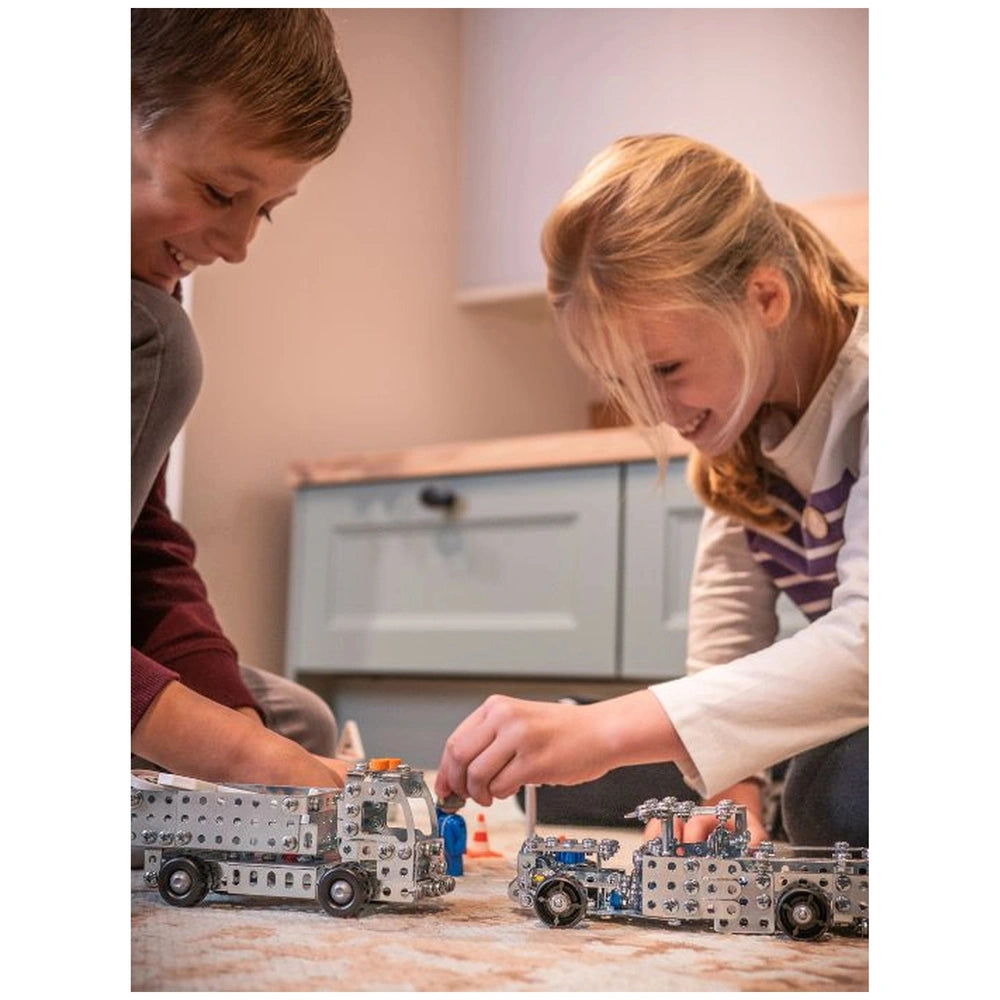 Eitech Excavator construction set toys, featuring two smiling children, one in a maroon top and one in white with purple, pla