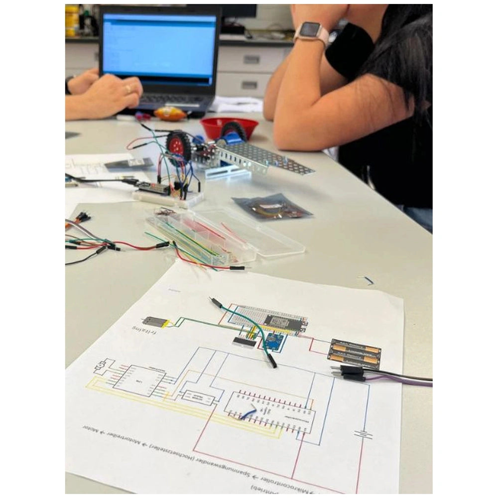Eitech Mini Concrete Mixer construction set features metal components, colorful wires, and a schematic paper layout on a plas