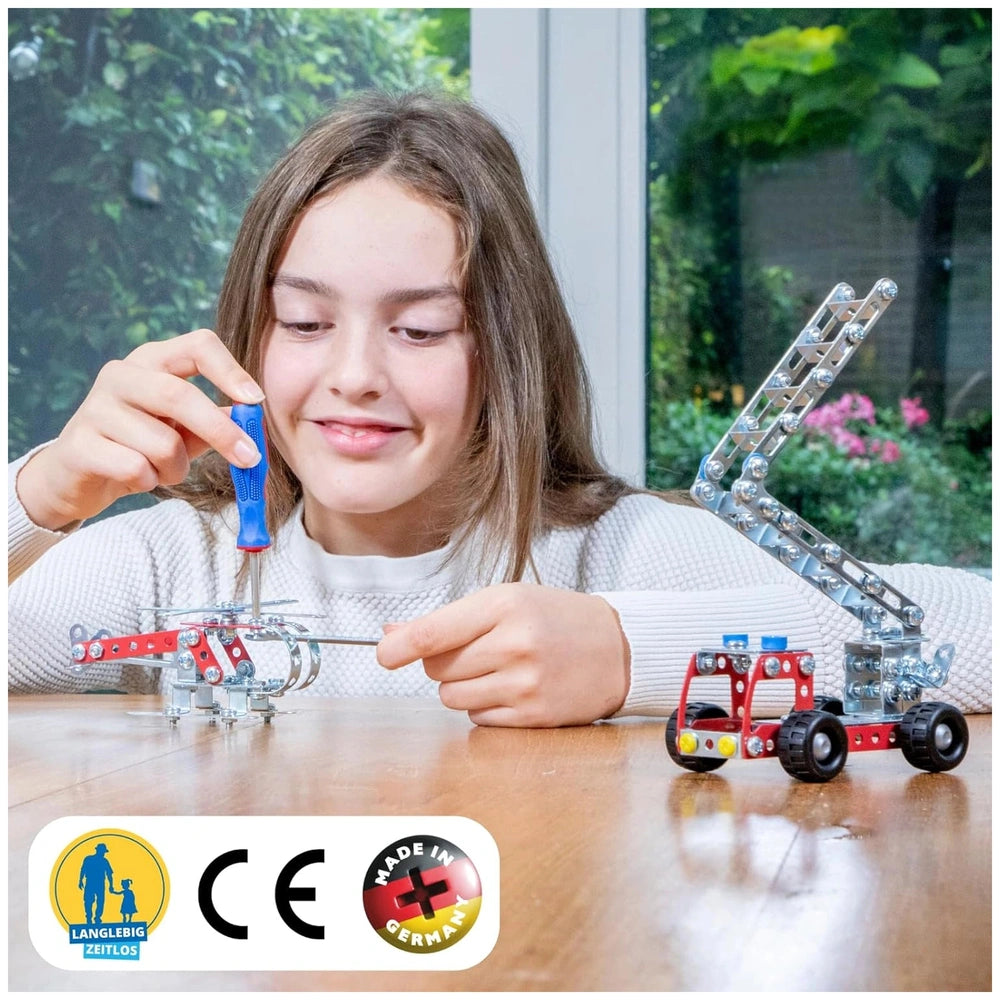 Eitech Rubin Rocket Racer green construction set toy with red and black wheels, held by a smiling girl in a white sweater.