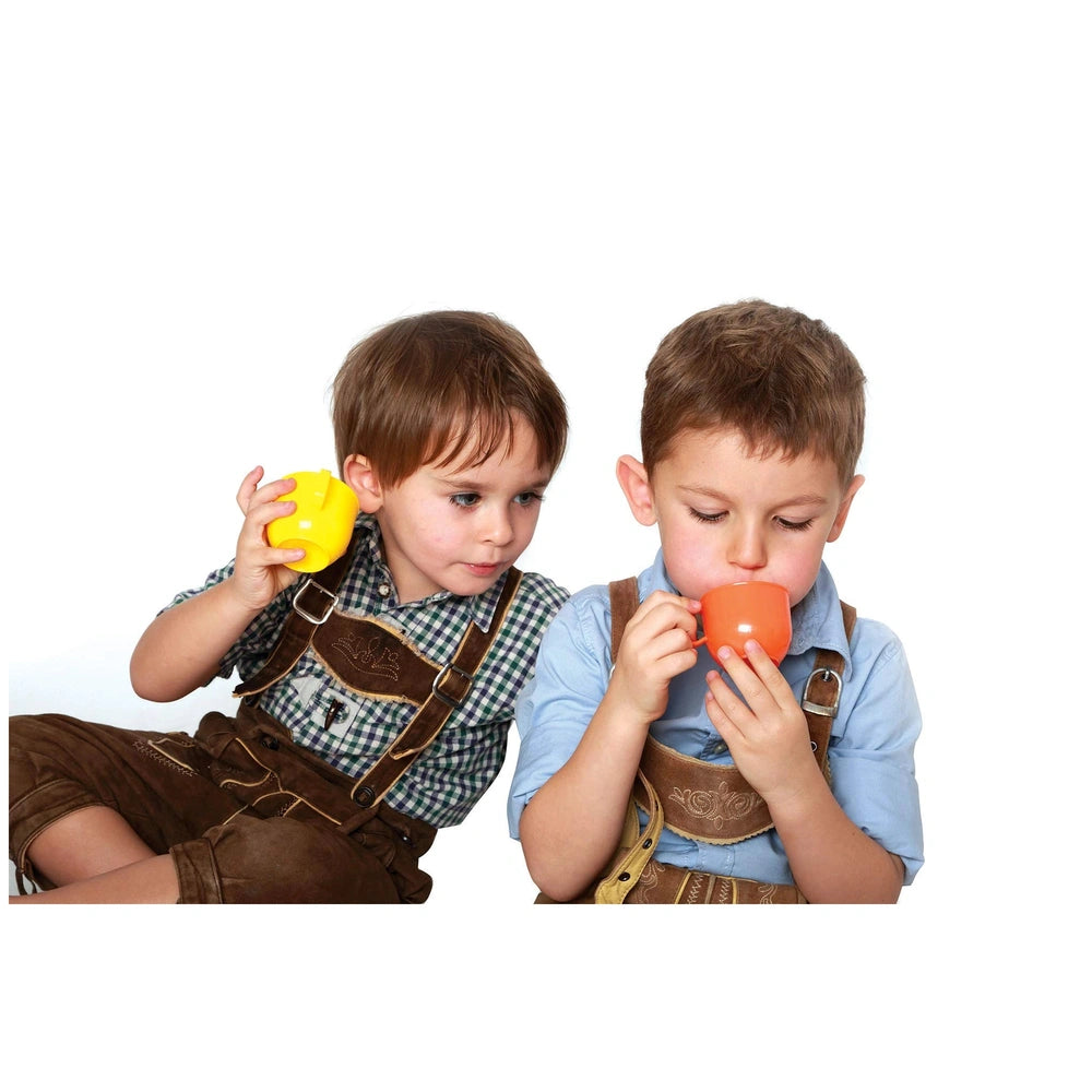 Gowi coffee service set with two children in suspenders holding orange plastic cups in a playful lifestyle scene.