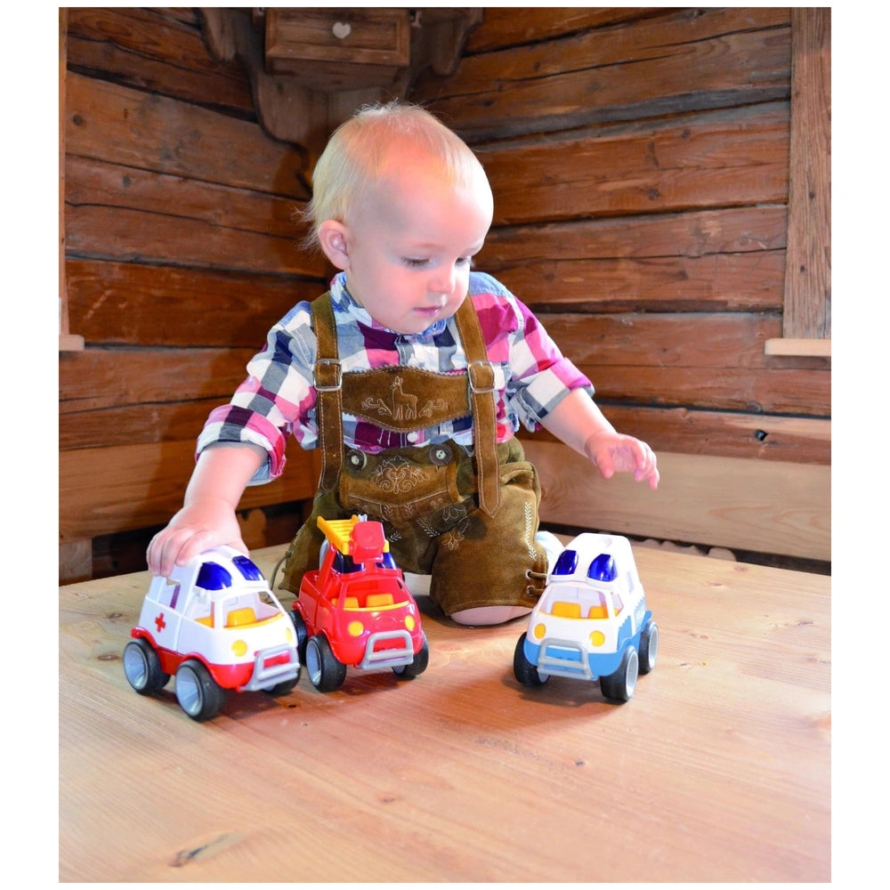Gowi concrete mixer toy in use by a child in plaid shirt and brown suspenders, holding a colorful toy car in a lifestyle scen