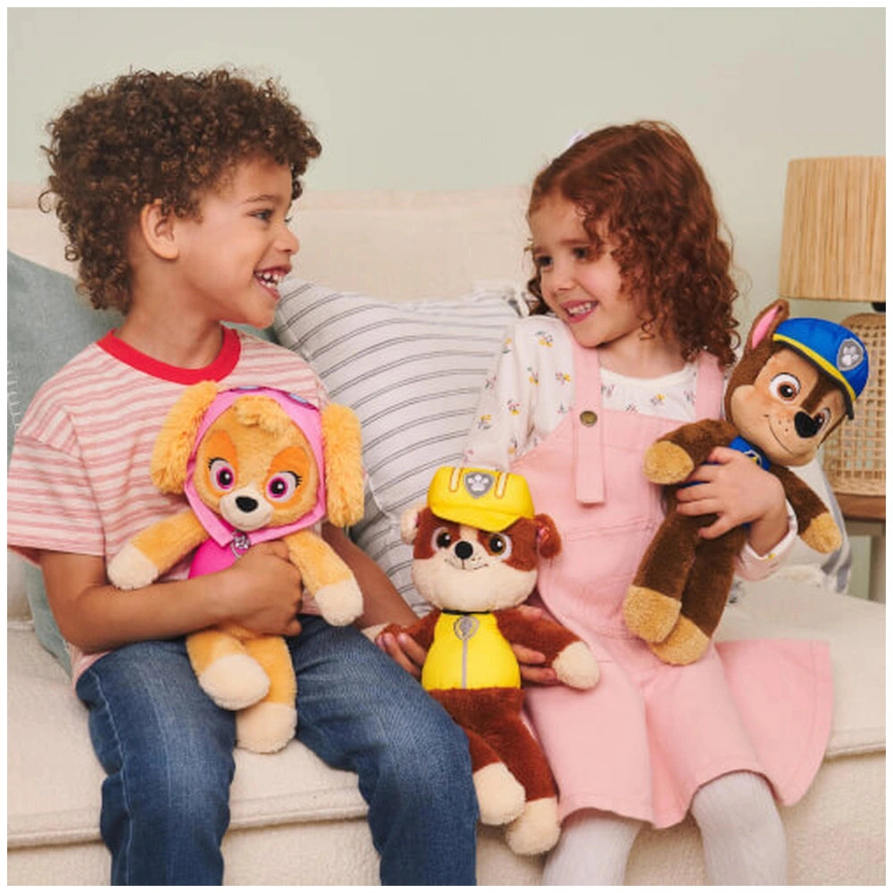 GUND Take Along Marshall Plush Toy is held by a smiling child in a pink dress on a white couch with another child.