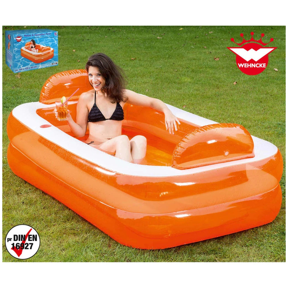 Happy People inflatable pool in orange, with a woman relaxing on green grass and blue and white product packaging nearby.