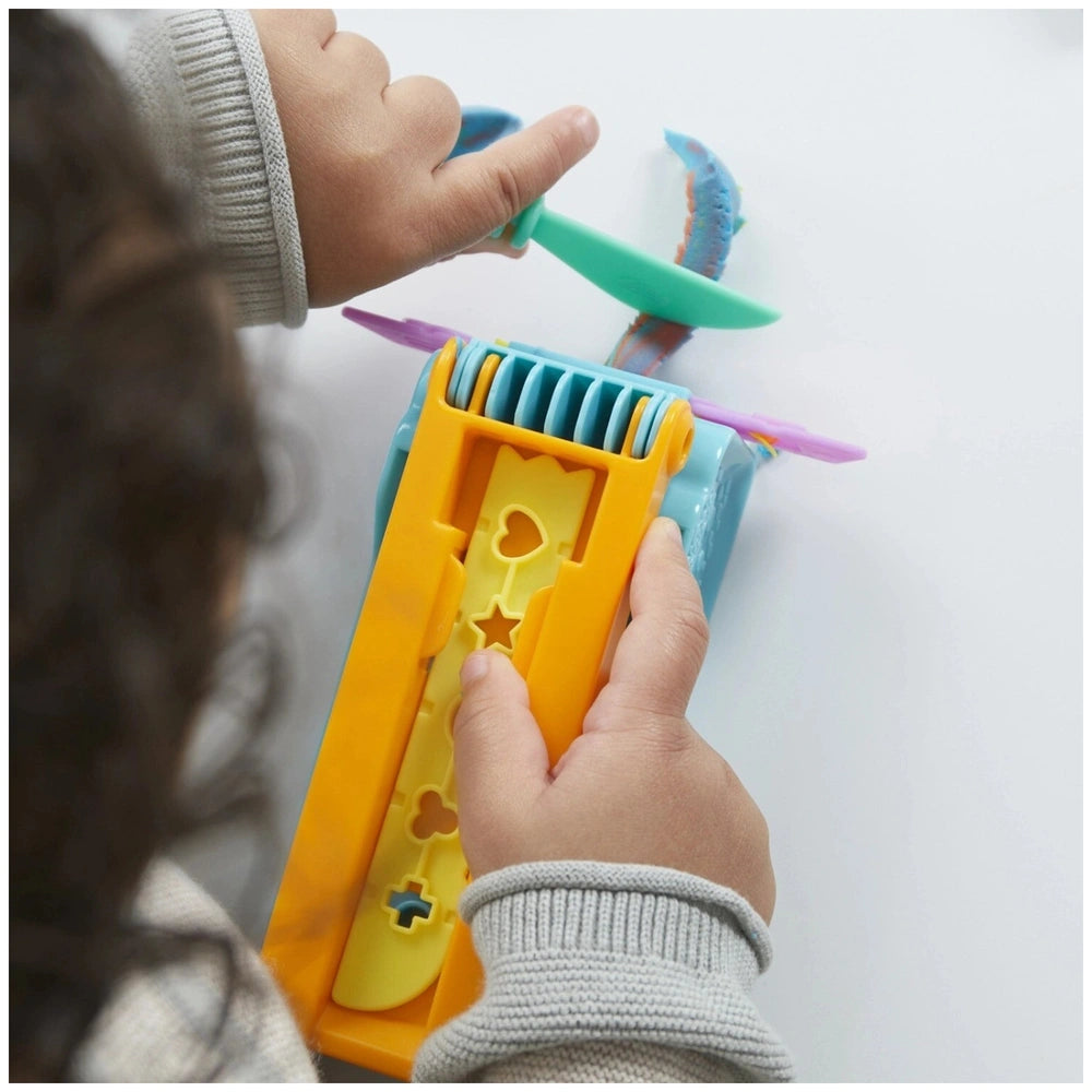 Play-Doh Fun Factory Starter Set with yellow, blue, and purple handles and buttons, showcasing a glossy and matte plastic des