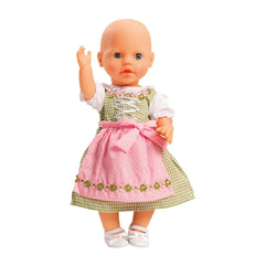 Heless Dirndl doll features a bald head, light brown hair, blue eyes, pink dress with green border, and white glossy shoes.