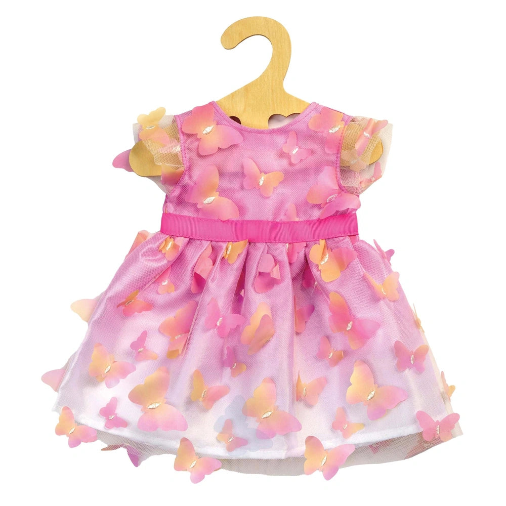 Heless Miss Butterfly dress for dolls, pink with white lining, adorned with pink and yellow butterflies, displayed on a woode