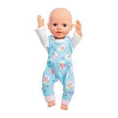 Heless Romper Unicorn Emil doll features a smiling face, blonde hair, and a blue floral jumpsuit with raised arms.