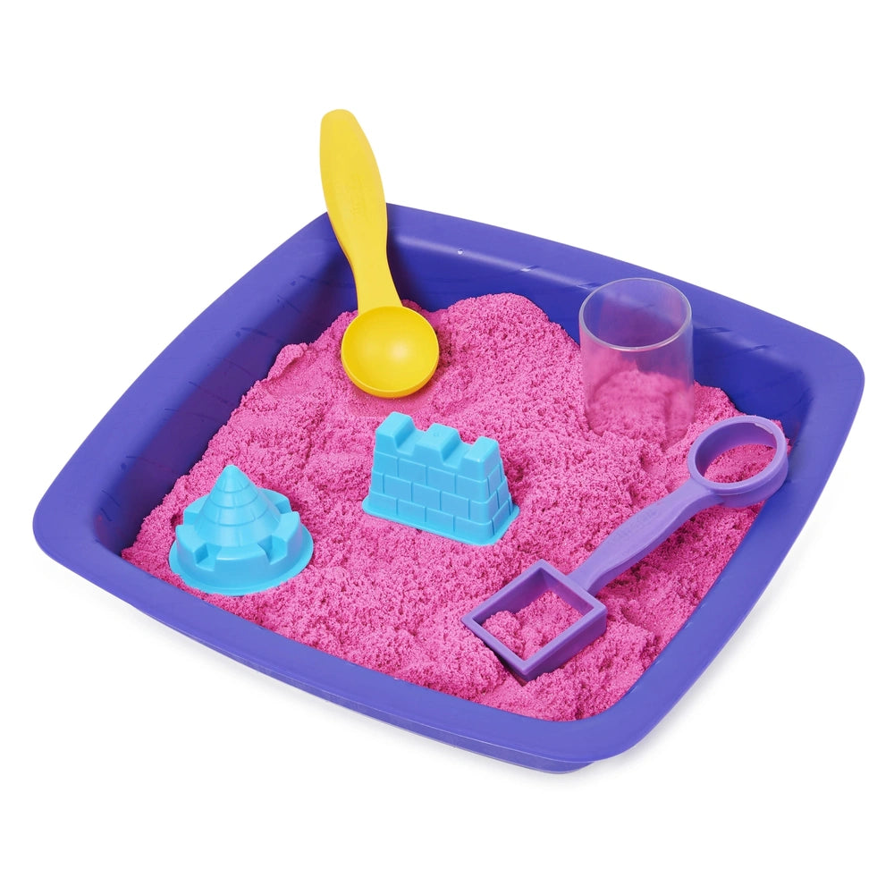 Kinetic Sand Shimmer Sparkle Sandcastle Set features pink sand, a blue tray, yellow spoon, purple shovel, and clear cup.