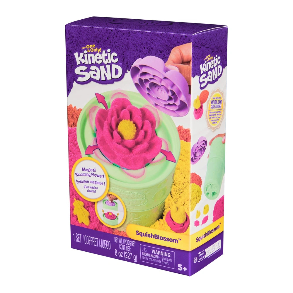 Kinetic Sand set features colorful sand in pink, yellow, and green, topped with a large pink flower in a vibrant purple box.