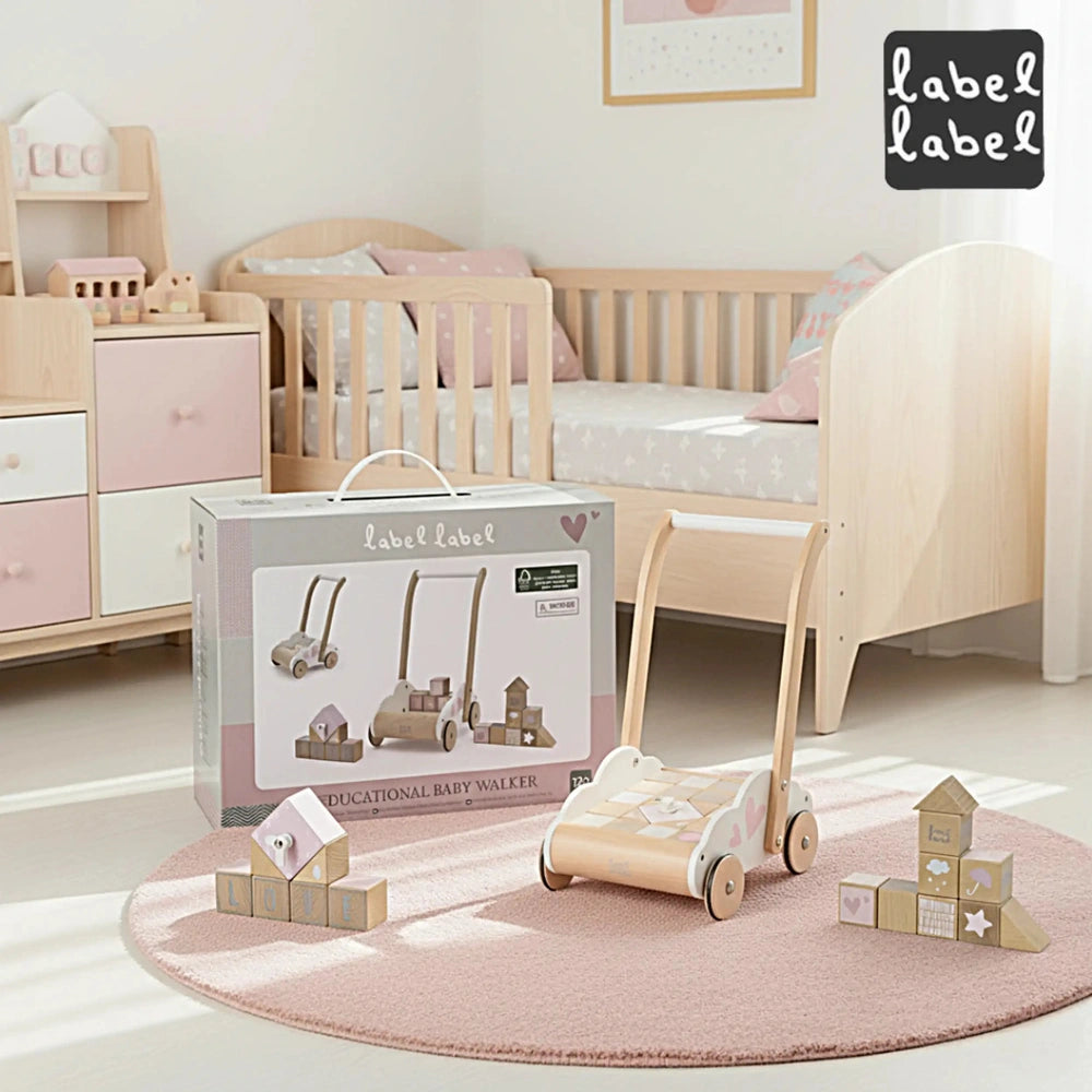 Educational baby walker toy in white packaging with pink accents, displayed in a bedroom with a pink rug and crib.