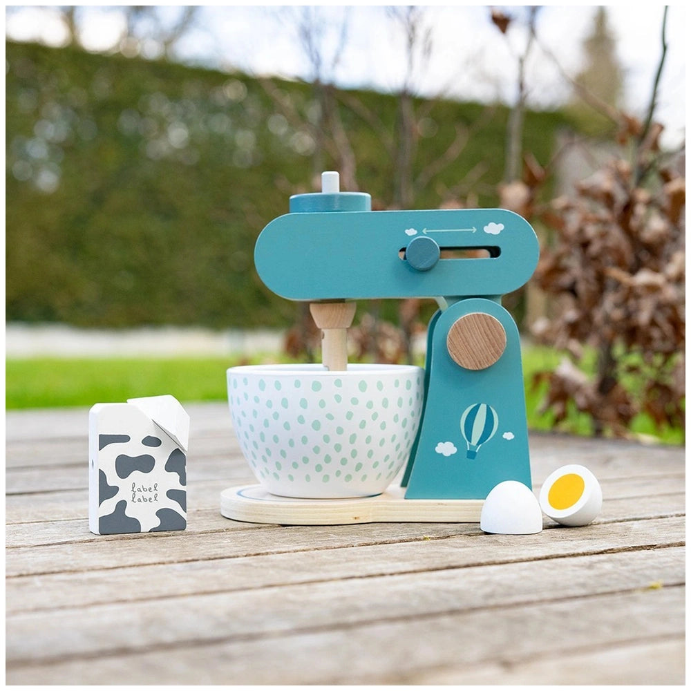 Label-Label Food Processor toy set featuring a polka dot bowl, yellow egg, blue glue gun, and cow-themed containers on a wood