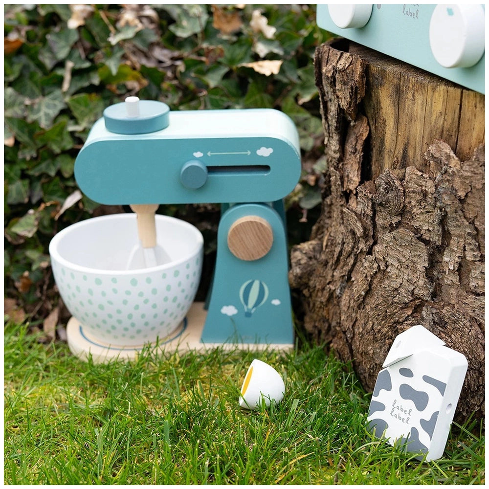 Label-Label Food Processor features a white bowl with blue rim and green dots on a blue wooden play kitchen countertop.
