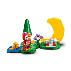 Lego Animal Crossing set features a red character holding a purple flower with a yellow moon on a green baseplate.