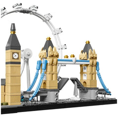 LEGO model of a beige clock tower with gold accents and a white Ferris wheel in the background against a gray sky.
