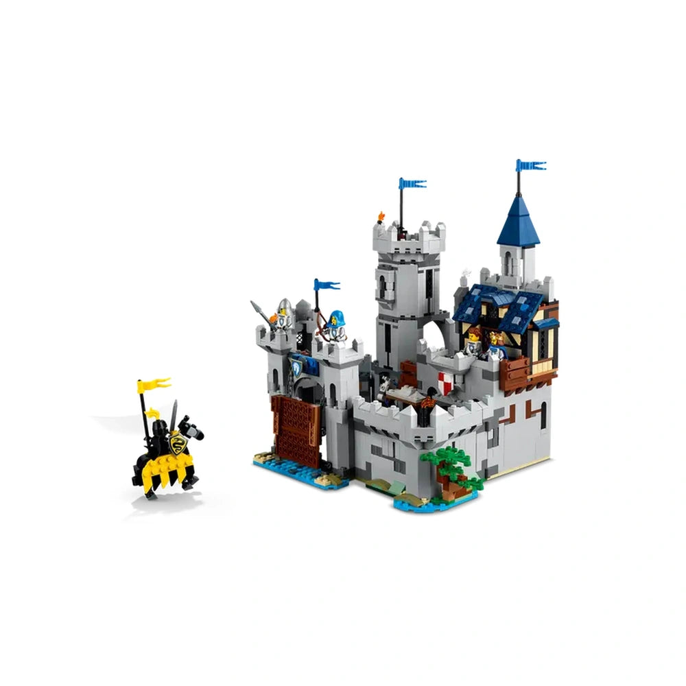 Medieval castle Lego set featuring a gray fortification with blue flags, a movable drawbridge, and two knights with horses, ready for adventure.