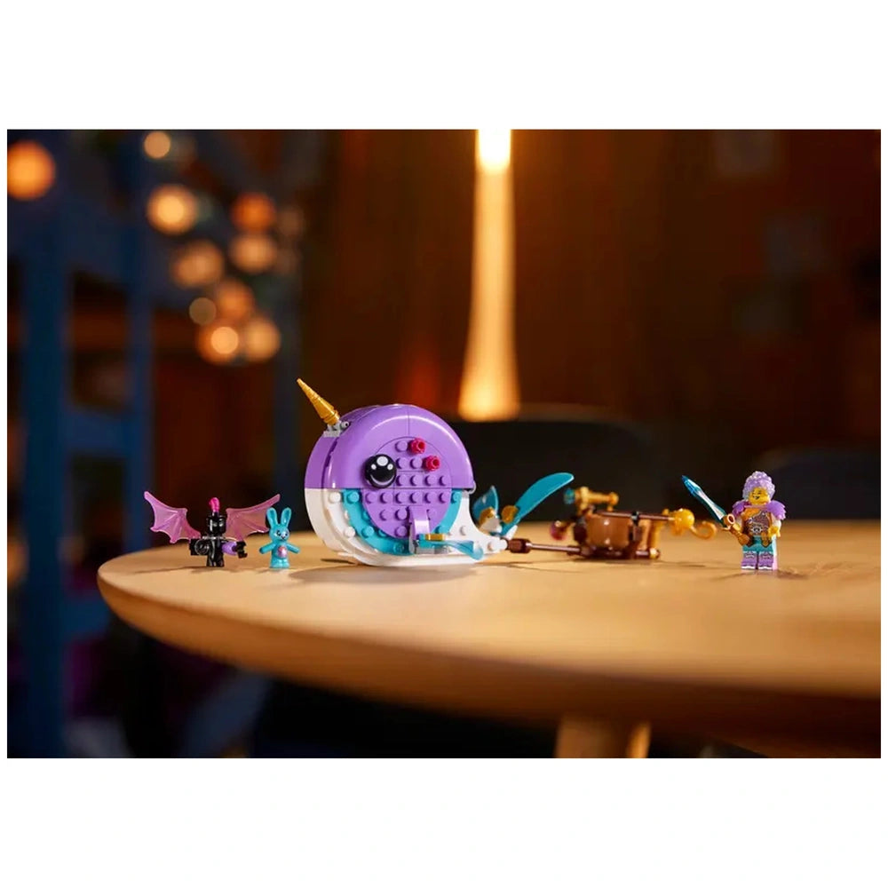Purple narwhal toy with a decorative horn sits on a wooden table, surrounded by a blue bunny, a black bat, and a character holding a sword.