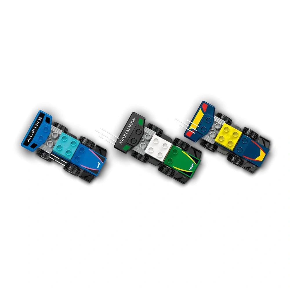 Colorful LEGO Duplo F1® race cars in blue, green, and black, each with distinctive branding and vibrant details, displayed on a white background.