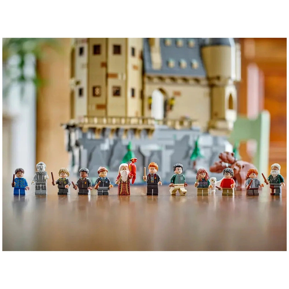 LEGO Harry Potter minifigures stand in front of Hogwarts Castle, featuring characters with wands, vibrant outfits, and detailed accessories.