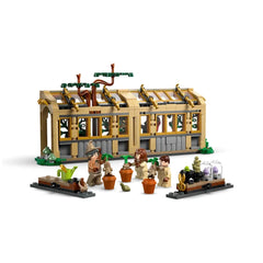 LEGO Hogwarts™ Castle Herbology Class set featuring a greenhouse, three minifigures tending magical plants in pots, and gardening tools.