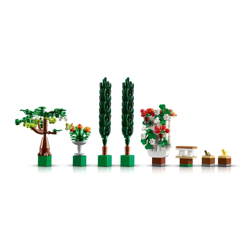 Colorful LEGO® floral elements, including two green cypress trees, a decorative flowerpot with orange roses, and a tiered white fountain, perfect for enhancing a garden display.