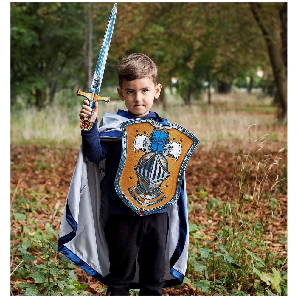 Liontouch Mystery Knight sword with metallic finish, blue and white cape, and shield in a lifestyle scene with one person.