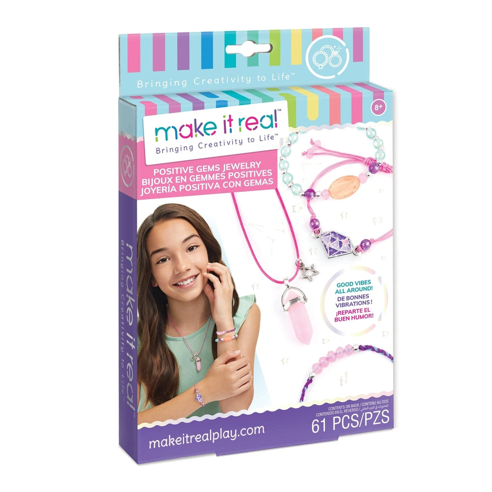 Positive Gems Jewelry packaging features a pink necklace, bracelet, hair tie, and clip with colorful printed text on glossy c