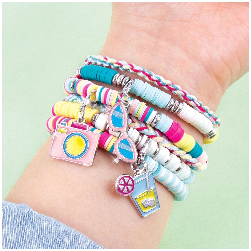 Colorful Summer Vibes Heishi bead bracelet featuring metal charms of a camera, lens, and film in pink, yellow, and blue.