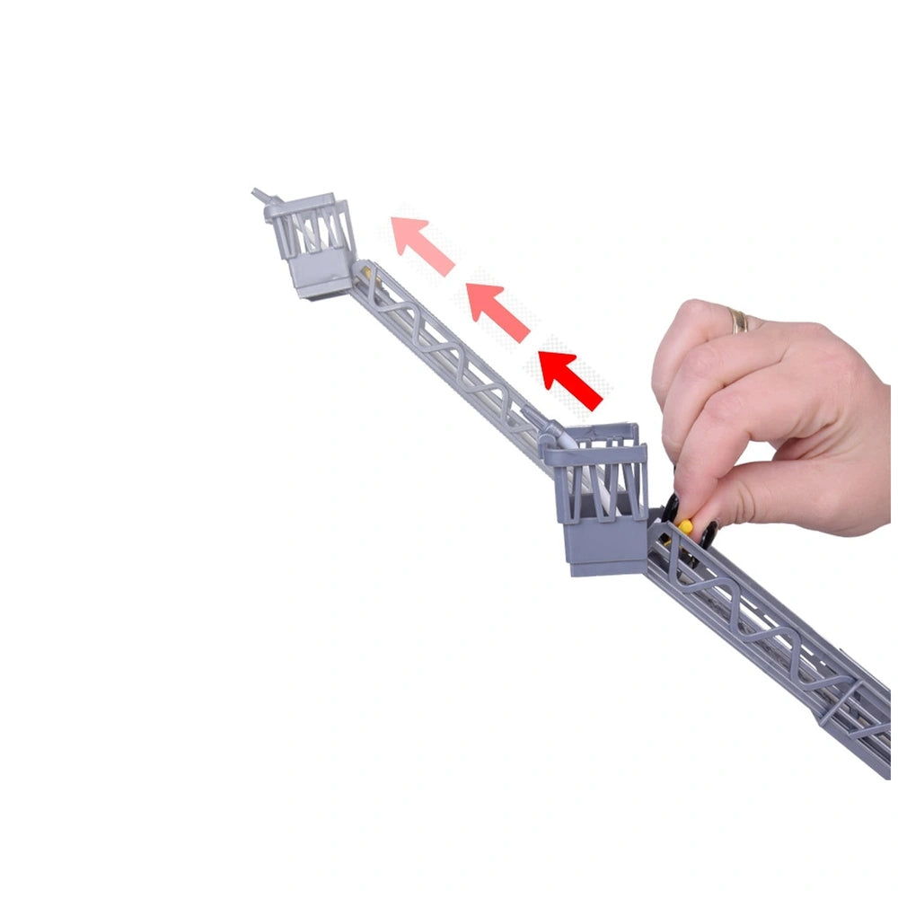 Metropoli fire engine toy is showcased with a hand holding a metallic piece of a model resembling a bridge structure.