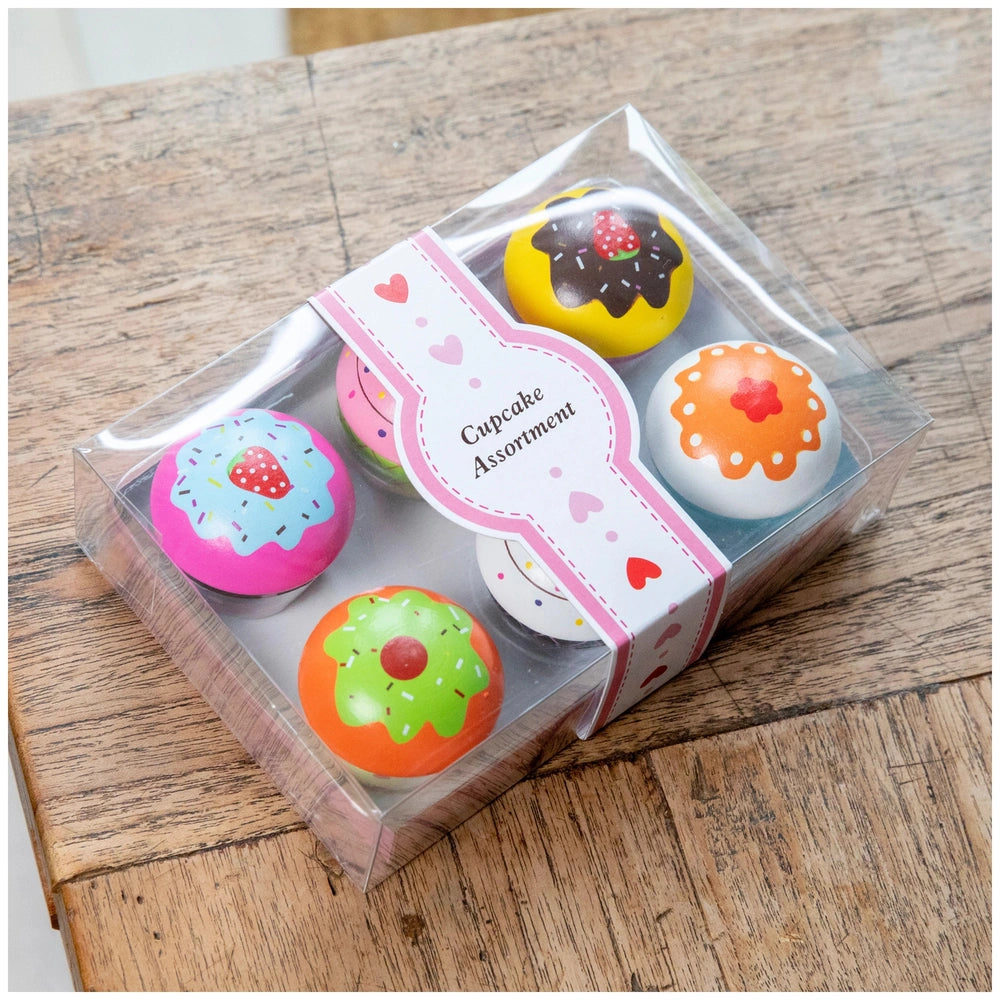 Cupcake assortment in a gift box featuring six colorful donuts with various icing designs and a heart label.