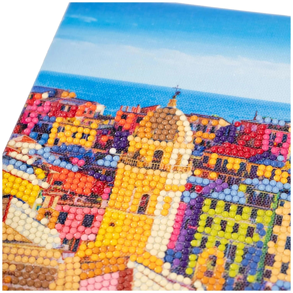 Diamantiny Artist Level Up painting on canvas featuring a vibrant cityscape with colorful buildings and clear blue sky.